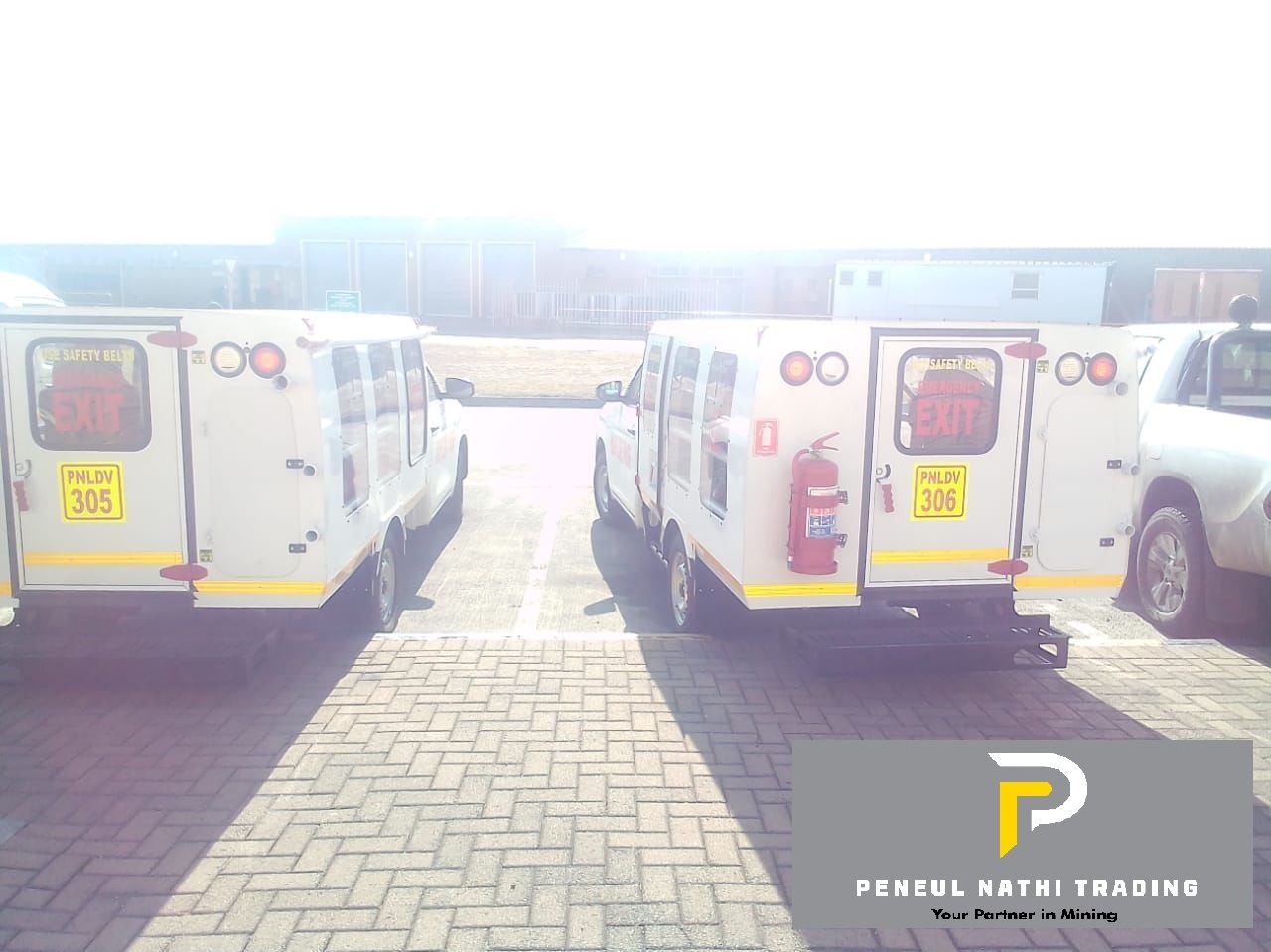 Personnel carrier interior with full-harness seating, fire suppression and emergency exit